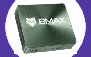 Compacte BMAX mini-pc met metalen behuizing, voorzien van logo en meerdere poorten aan de voorkant, geplaatst op een witte achtergrond met paarse cirkels eromheen.